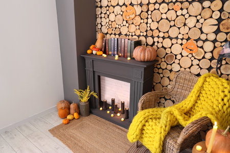 Interior of living room with wicker armchair, fireplace and Halloween decorationsの写真素材