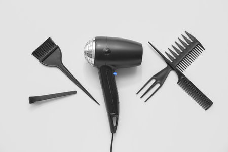 Hair dryer, brush and combs on light background, top viewの写真素材