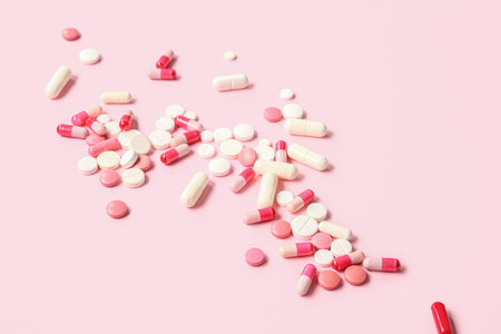 Many different pills on pink backgroundの写真素材
