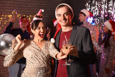 Couple of friends with champagne at New Year party
