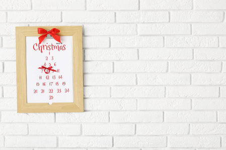 Christmas calendar on white brick wallの写真素材