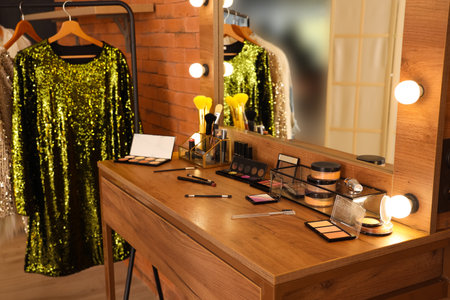 Stylish mirror, clothes rack and table with makeup cosmetics in dressing roomの写真素材