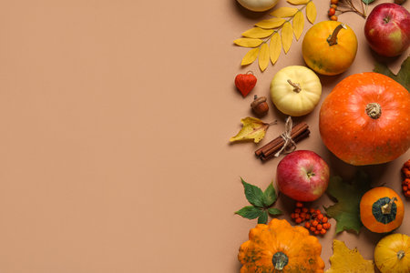 Beautiful autumn composition with ripe pumpkins and natural forest decor on color backgroundの写真素材
