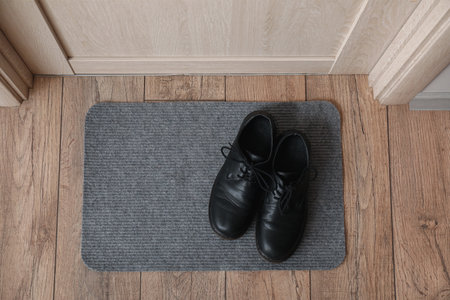 Doormat with shoes in hall, top viewの写真素材