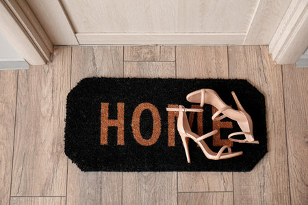 Doormat with heels in hall, top view