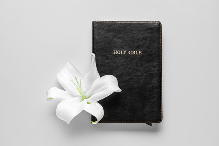 Beautiful lily flower and Holy Bible on gray backgroundの写真素材