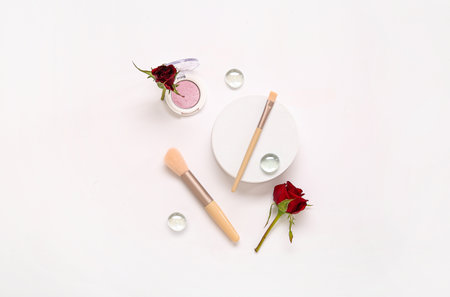 Composition with makeup products and beautiful red rose flowers on white backgroundの写真素材