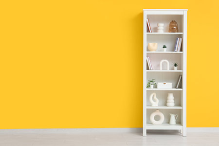 Modern shelf unit near orange wallの写真素材