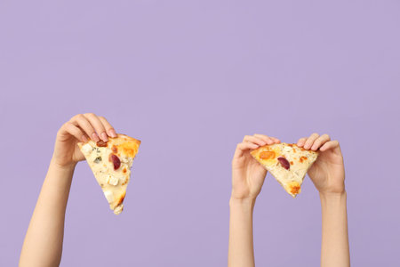 Many hands holding tasty pizza slices on lilac backgroundの写真素材