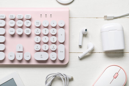 Composition with different modern gadgets on white wooden background, closeup