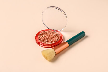 Makeup brush and highlighter on pink backgroundの写真素材