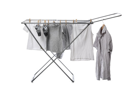 Dryer with clean clothes on white backgroundの写真素材