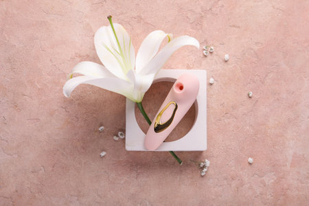 Decorative podium with vibrator and flowers on grunge backgroundの写真素材