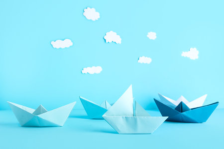 Colorful origami boats on blue backgroundの写真素材