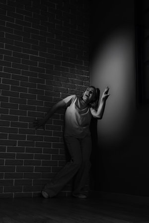 Scared mature woman in cornerの写真素材