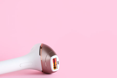 Modern photoepilator on pink backgroundの写真素材