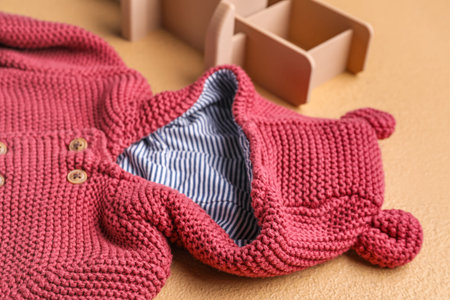 Stylish baby sweater and toy plane on color background, closeupの写真素材
