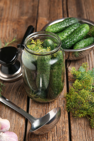 Jar with fresh cucumbers for canning on wooden backgroundの写真素材