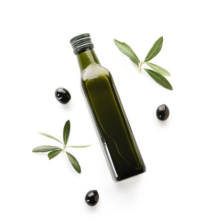 Glass bottle with olive oil and leaves on white backgroundの写真素材