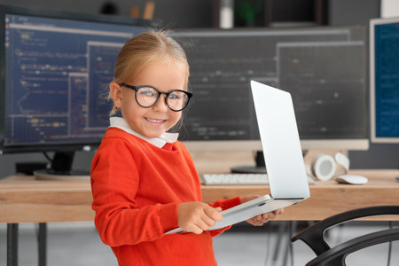 Cute little programmer girl with laptop in officeの写真素材