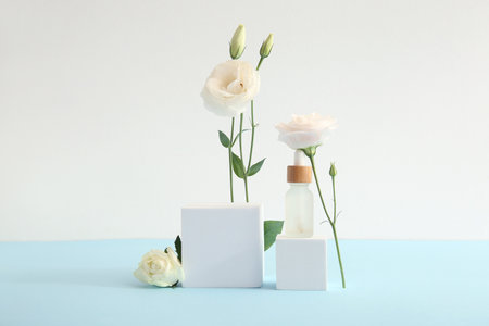 Composition with bottle of essential oil, plaster podium and beautiful eustoma flowers on color backgroundの写真素材