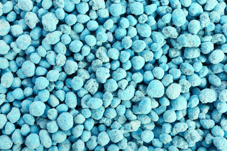 Closeup view of blue granular fertilizer as backgroundの写真素材