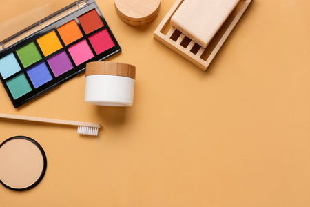 Set of cosmetic products and toothbrush on color backgroundの写真素材