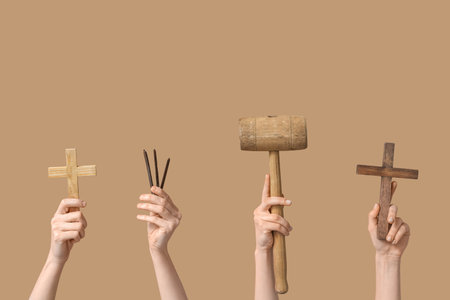 Female hands with wooden crosses, nails and mallet on color background. Good Friday conceptの写真素材