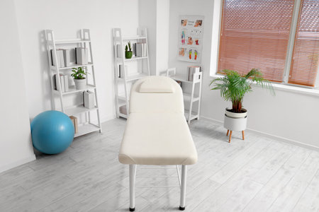 Interior of rehabilitation center with couch and shelf unitsの写真素材