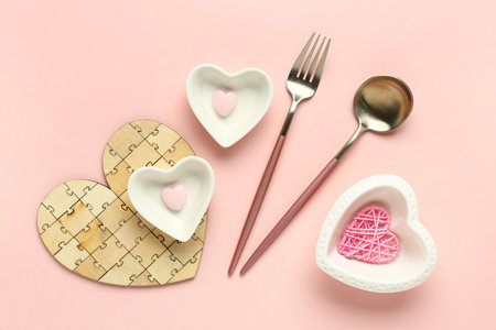 Beautiful table setting with bowls in shape of hearts on pink background. Valentine's Day celebrationの写真素材