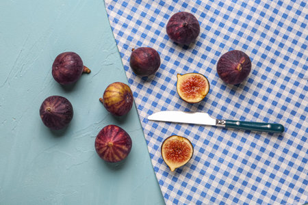 Fresh ripe figs on blue background