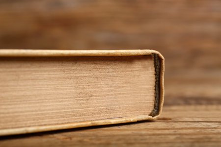 Old hardcover book on wooden background, closeupの写真素材