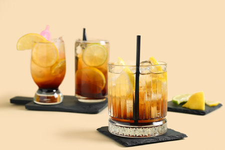 Glasses of delicious Long Island iced tea on color backgroundの写真素材