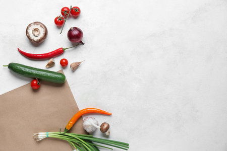 Paper bag and different products on white backgroundの写真素材