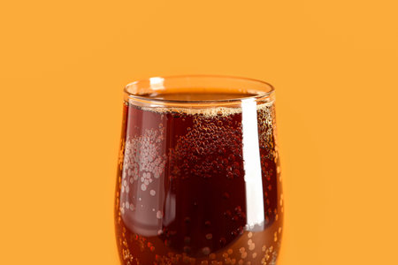 Glass of tasty kvass on orange backgroundの写真素材