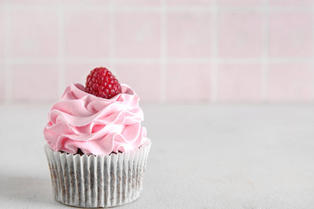Tasty raspberry cupcake on tableの写真素材