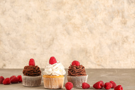 Tasty cupcakes with raspberries on tableの写真素材