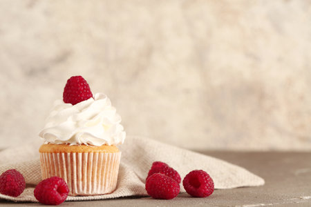 Tasty raspberry cupcake on tableの写真素材