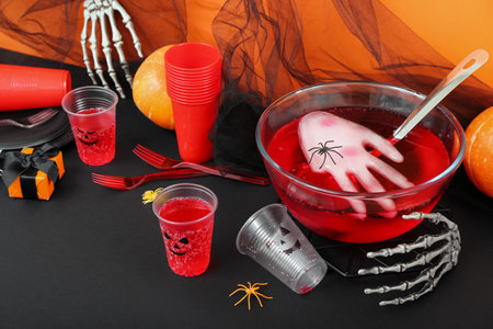 Halloween party composition with punch, pumpkins and decor on black tableの写真素材