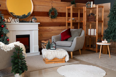 Interior of festive living room with Christmas tree, fireplace and armchairsの写真素材