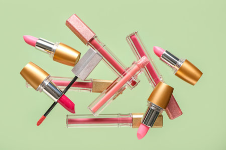Beautiful lipsticks flying on color backgroundの写真素材