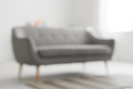 Blurred view of stylish modern living room with gray sofaの写真素材