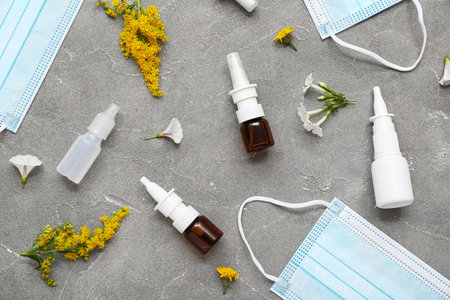 Nasal drops with flowers and medical masks on grunge backgroundの写真素材