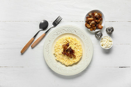 Plate of tasty banosh and ingredients on white wooden backgroundの写真素材