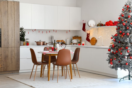 Interior of modern kitchen with festive table setting, Christmas tree and decorの写真素材