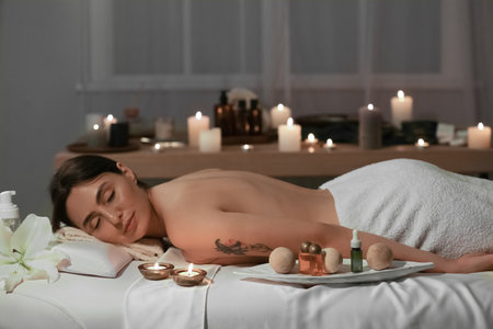 Young woman relaxing in dark spa salonの写真素材