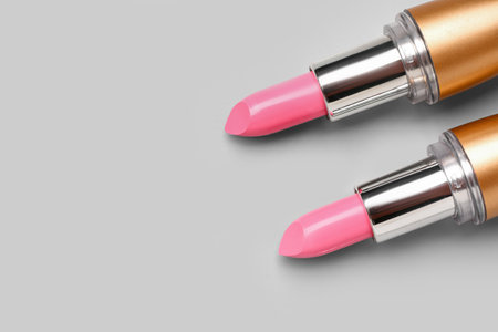 Stylish pink lipsticks on light background, closeupの写真素材