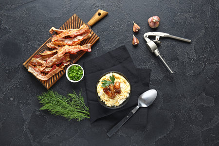 Bowl of tasty banosh and bacon on black backgroundの写真素材