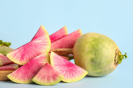 Pieces of ripe watermelon radish on blue backgroundの写真素材