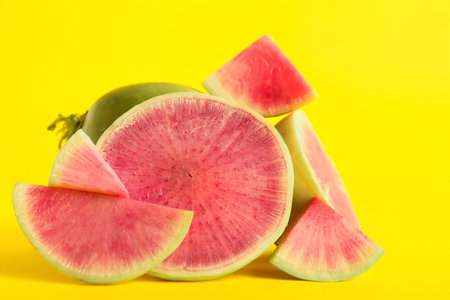 Cut fresh watermelon radish on yellow backgroundの写真素材